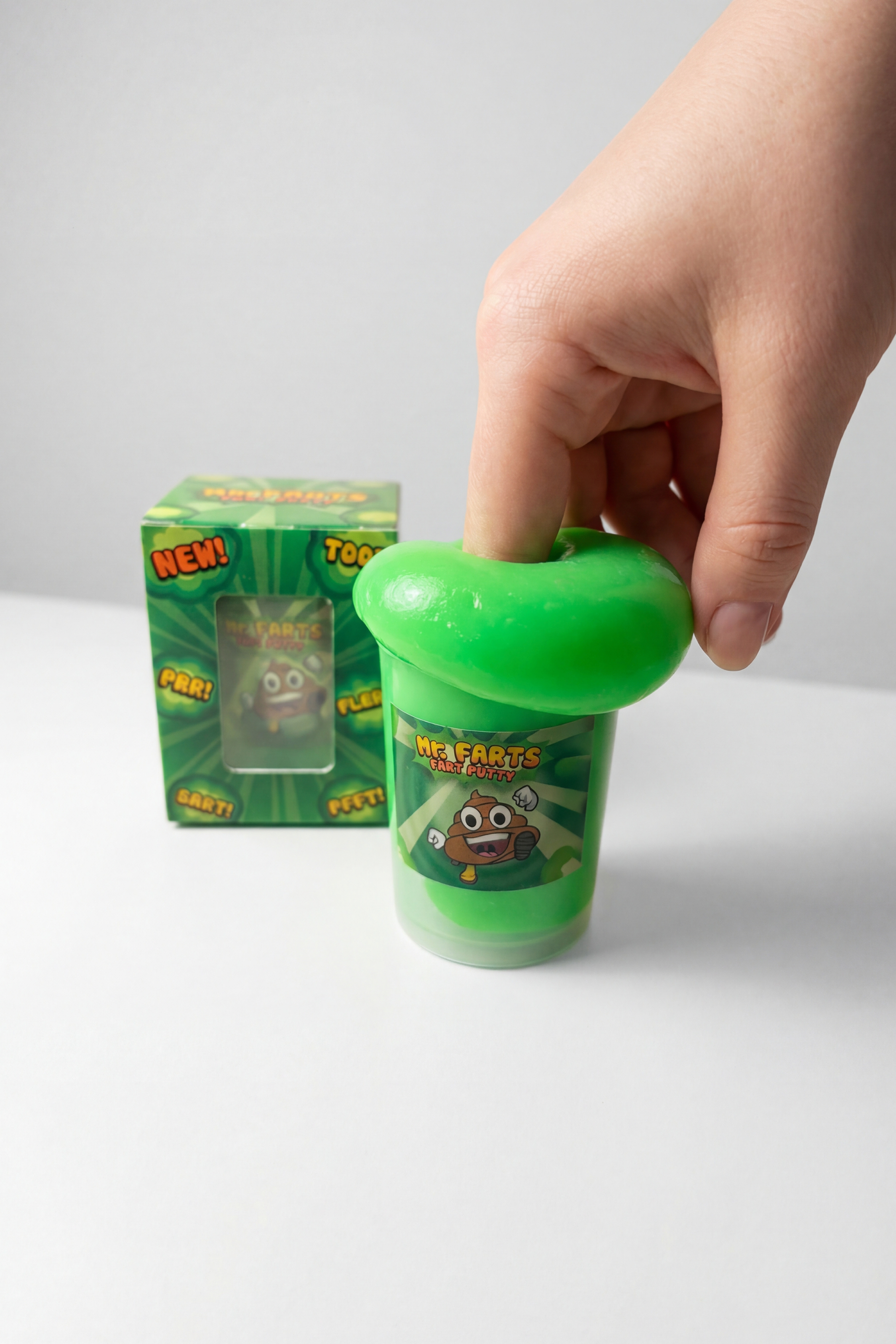 my farts fart putty out of the box and someone playing with by using their fingers. 