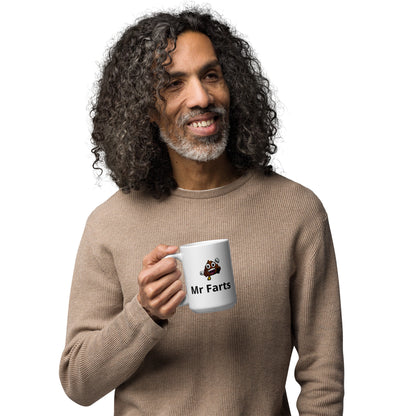 Adult sized Mr Farts mug in man's hand looking happy 